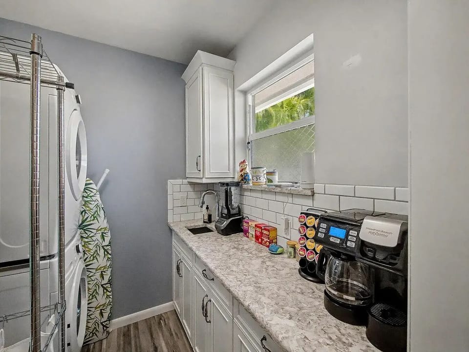 Start your morning right at the built-in coffee bar, conveniently tucked alongside the home's laundry amenities.