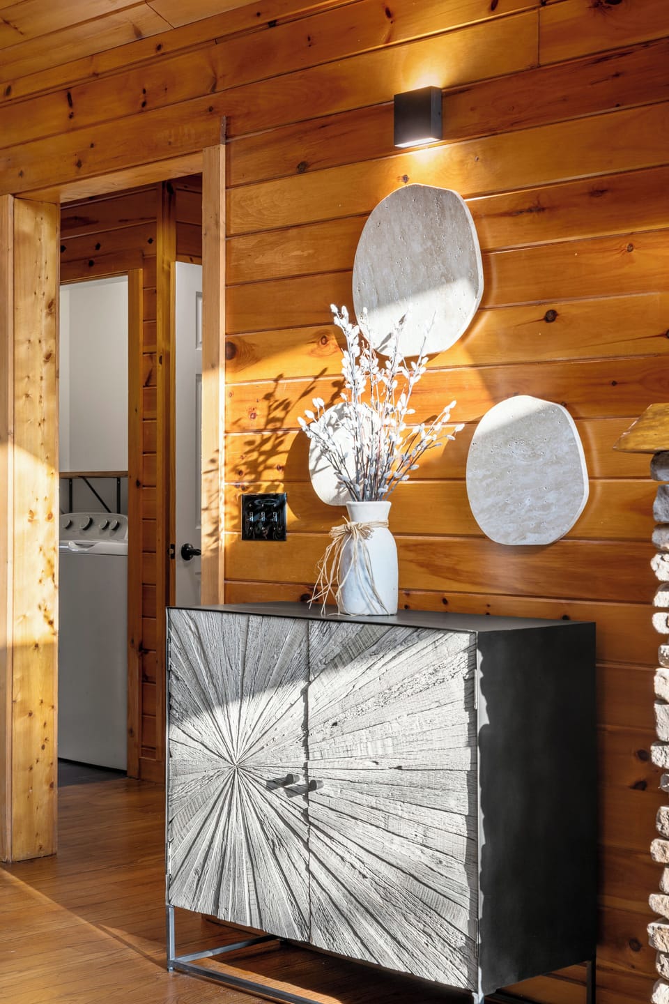 Warm wood-paneled entry with modern décor and convenient in-unit laundry