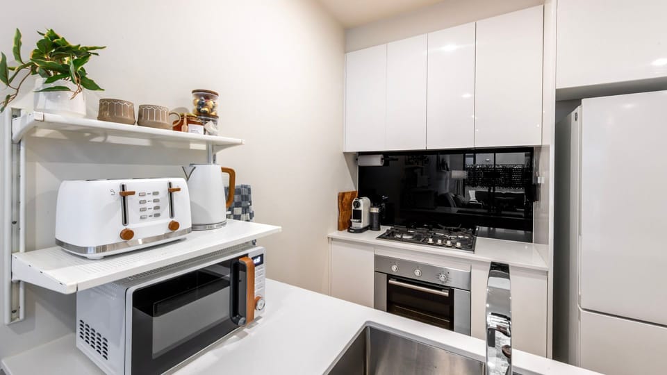 The fully equipped kitchen offers modern appliances and ample space for cooking.
