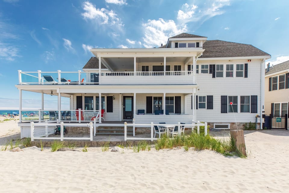 The house is directly on the sand and features ample outdoor seating