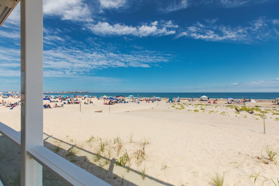 The beach is the yard! Prime location a 1 minute walk to downtown Hampton