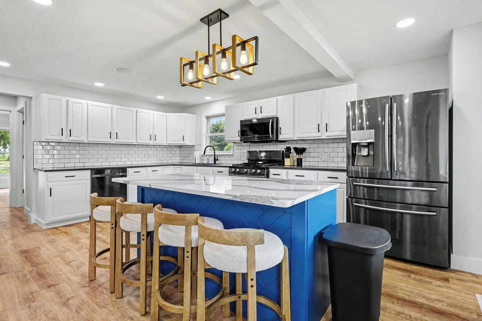 Bright, fully remodeled kitchen with large island seating and plenty of room to gather.