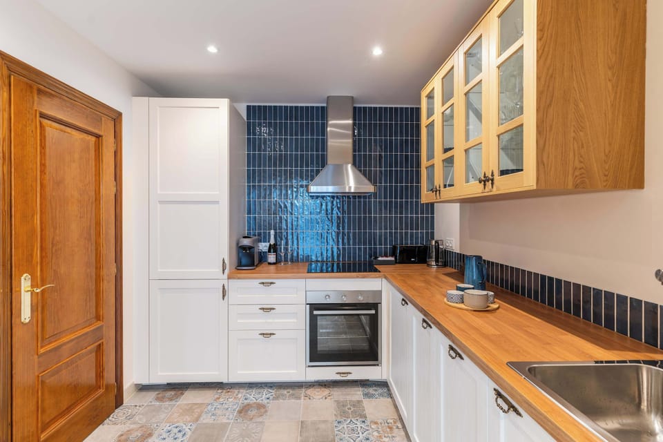 The separate kitchen features an induction hob, oven, dishwasher, fridge, coffee machine, kettle, washing machine and tumble dryer. Cookware, tableware and basic utensils are provided, along with coffee, tea and spices.