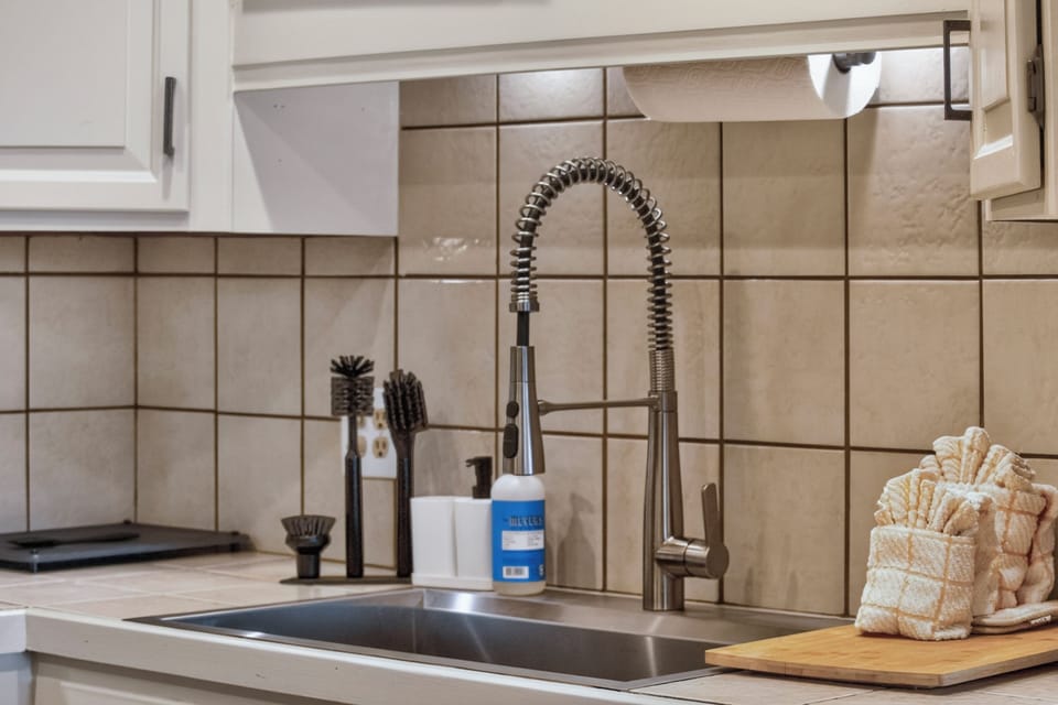 A sleek, modern kitchen awaits you, complete with a professional-style faucet and all the essentials for preparing your favorite meals during your stay.