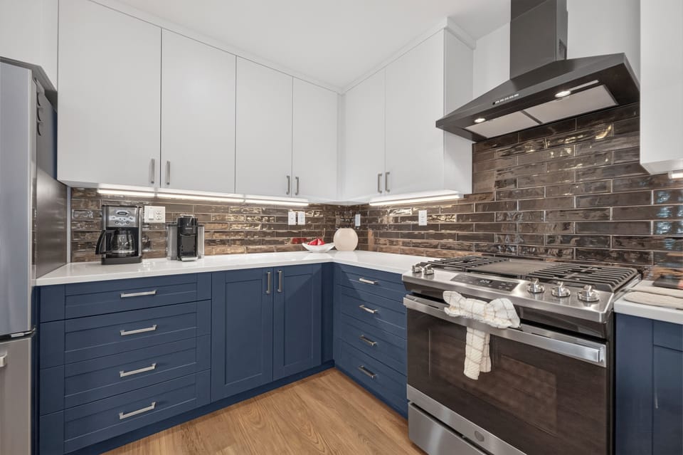 Your fully equipped gourmet kitchen features modern appliances, elegant cabinetry, and ambient under-cabinet lighting—perfect for preparing delicious home-cooked meals during your stay.