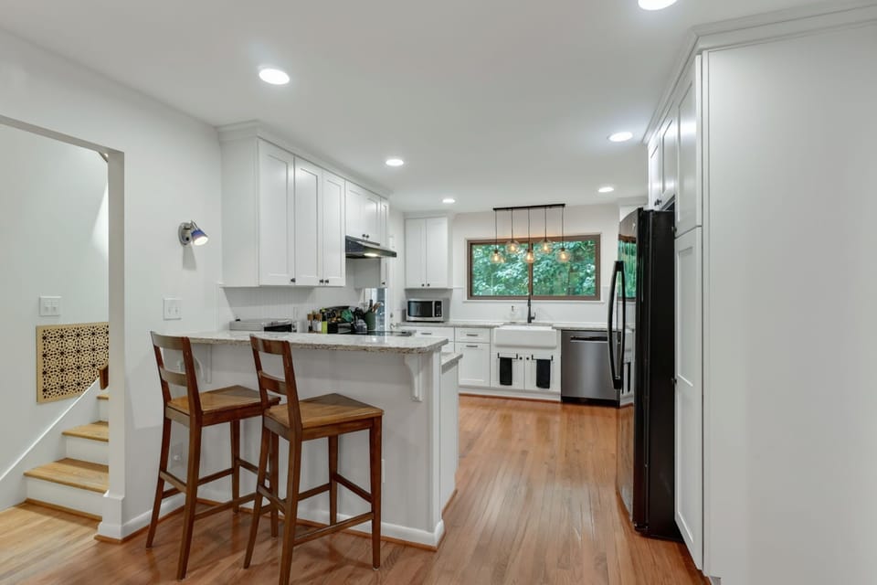 The kitchen has a breakfast bar counter to eat or work