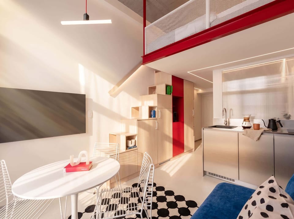 Living room with kitchen and stairs to the upper floor
