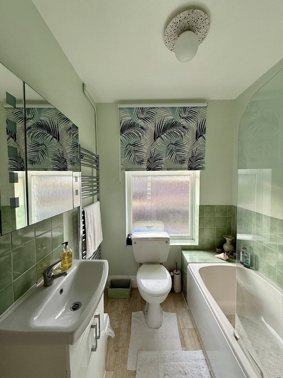 Bathroom with bath and shower over bath