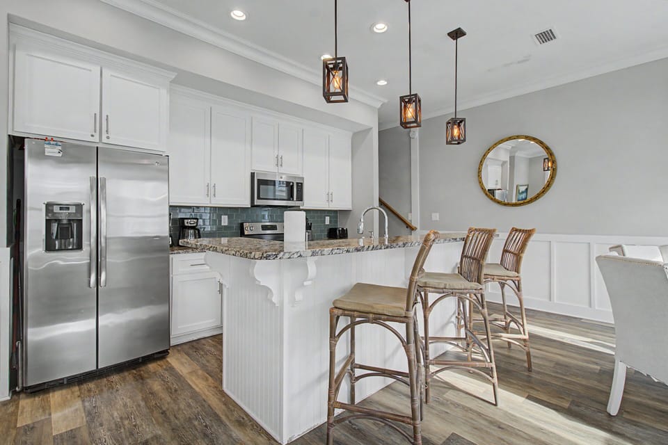 Granite breakfast island invites you to linger over morning coffee in the open kitchen and dining area