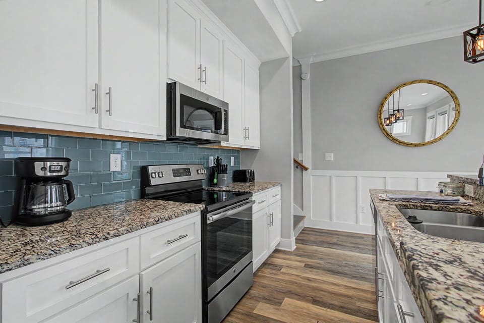 The kitchen features sleek stainless steel appliances for all your culinary creations