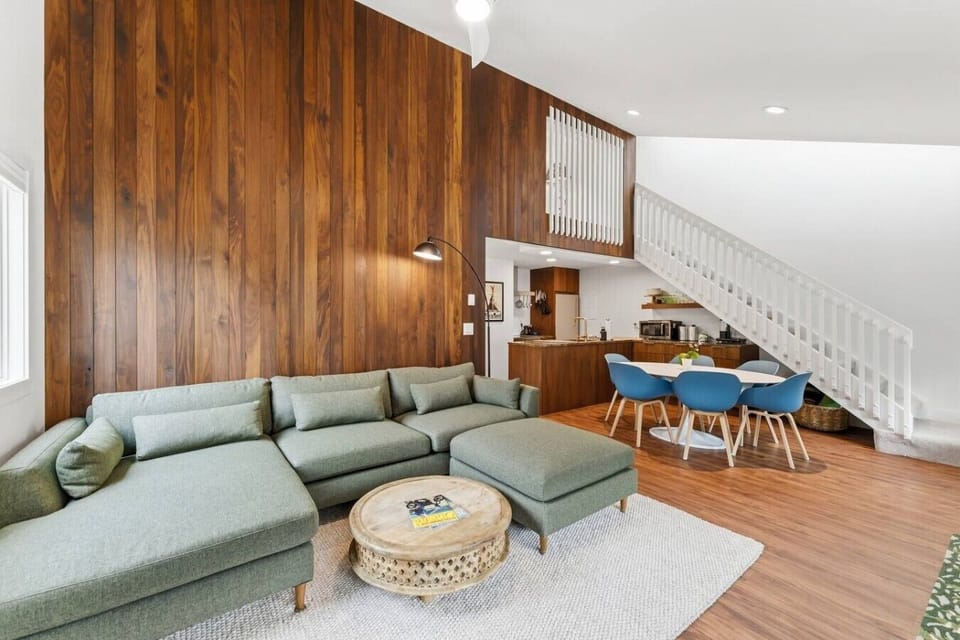Mid Century living room with comfy seating and vaulted ceilings