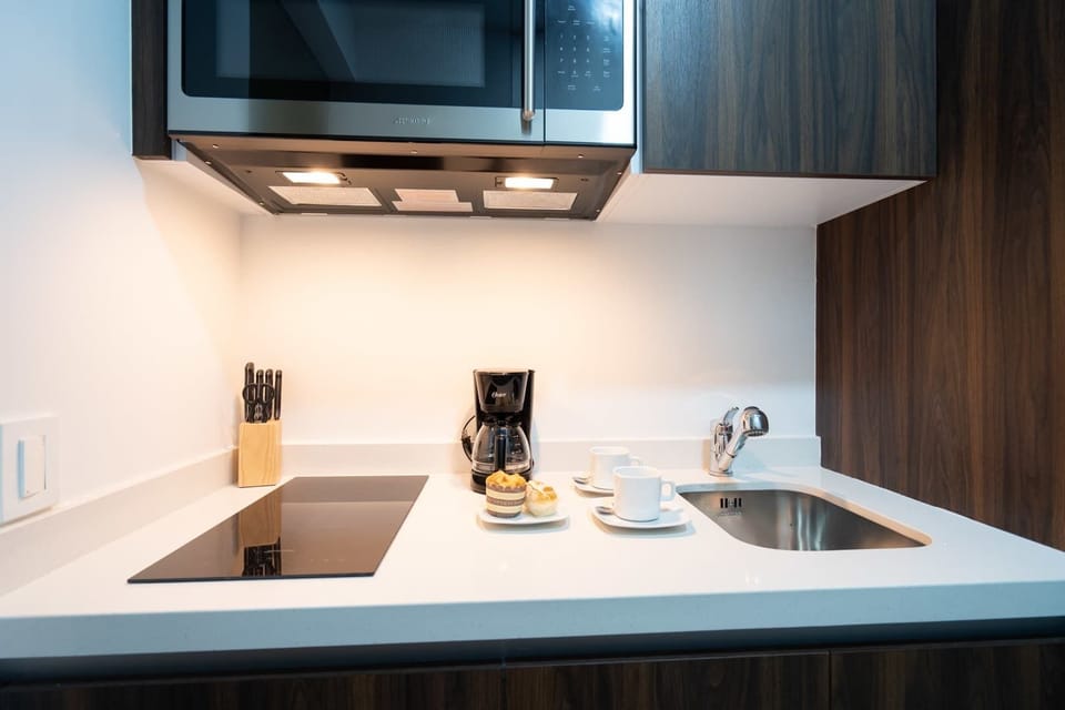 Modern kitchenette with stovetop and prep space for easy home-cooked meals