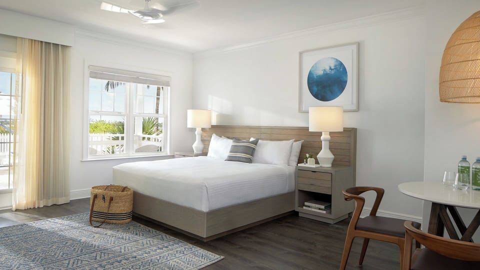 Unwind in crisp linens with airy, coastal views outside.