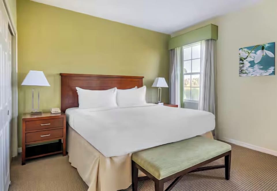 Relax in a classic, spacious bedroom with soft lighting.