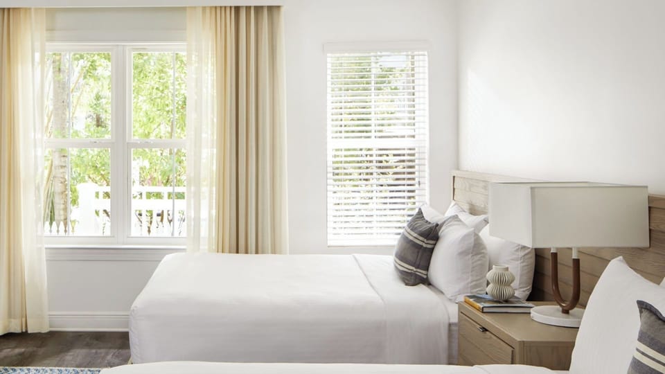 Wake up to sunshine filtering through palms beside cozy twin beds.