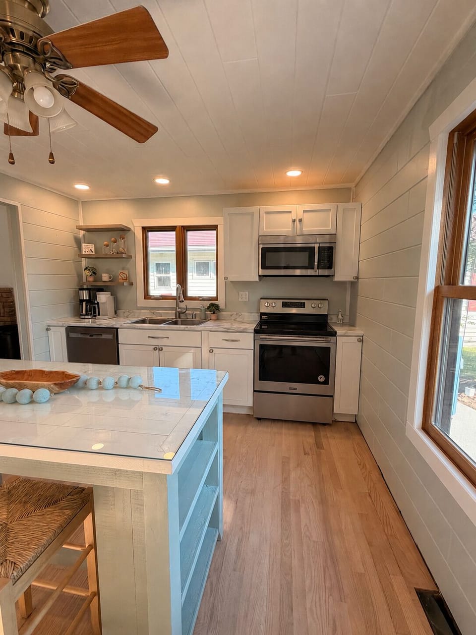 Bright modern farmhouse kitchen with island and stainless appliances
