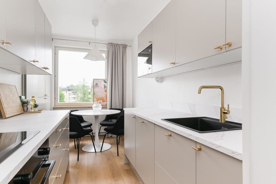 Renovated 2026 kitchen with brass tap and marble counters - Sammonkatu 5 B 22