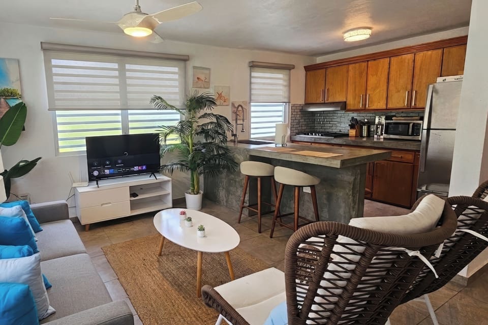 Bright open living area with breakfast bar and stylish, sunlit seating