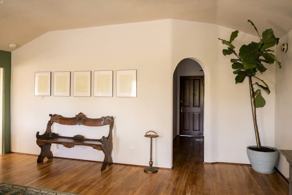 Charming entryway with vintage bench and arched doorway