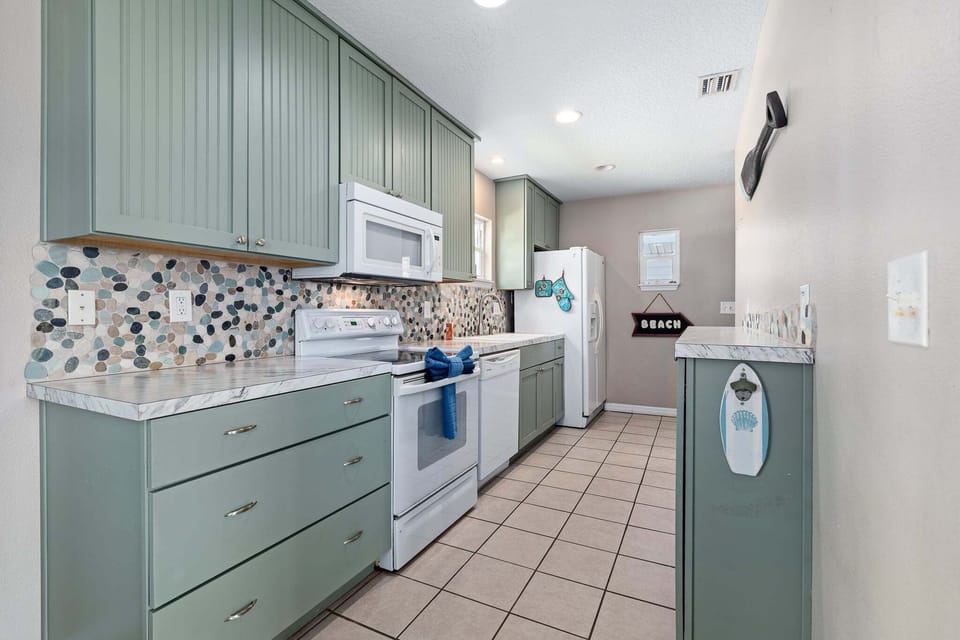 The kitchen is fully equipped with all the appliances and essentials you need for cooking at home.