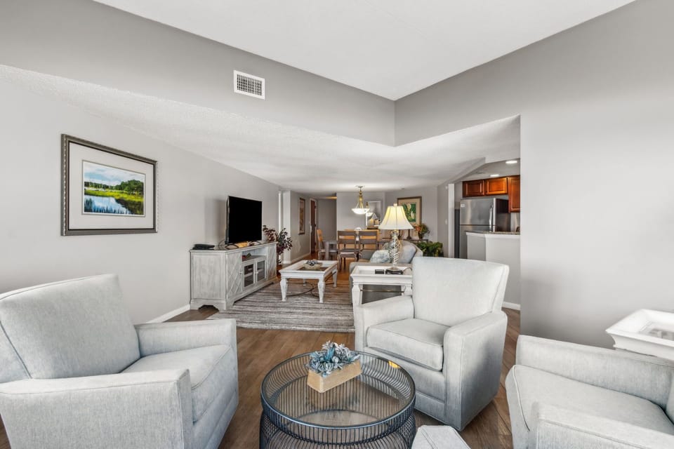 Spacious Living Room Featuring Panoramic Oceanfront Views, Seating Area with Plush Swivel Chairs, and a Flat Screen Smart TV (Sleeper Sofa)