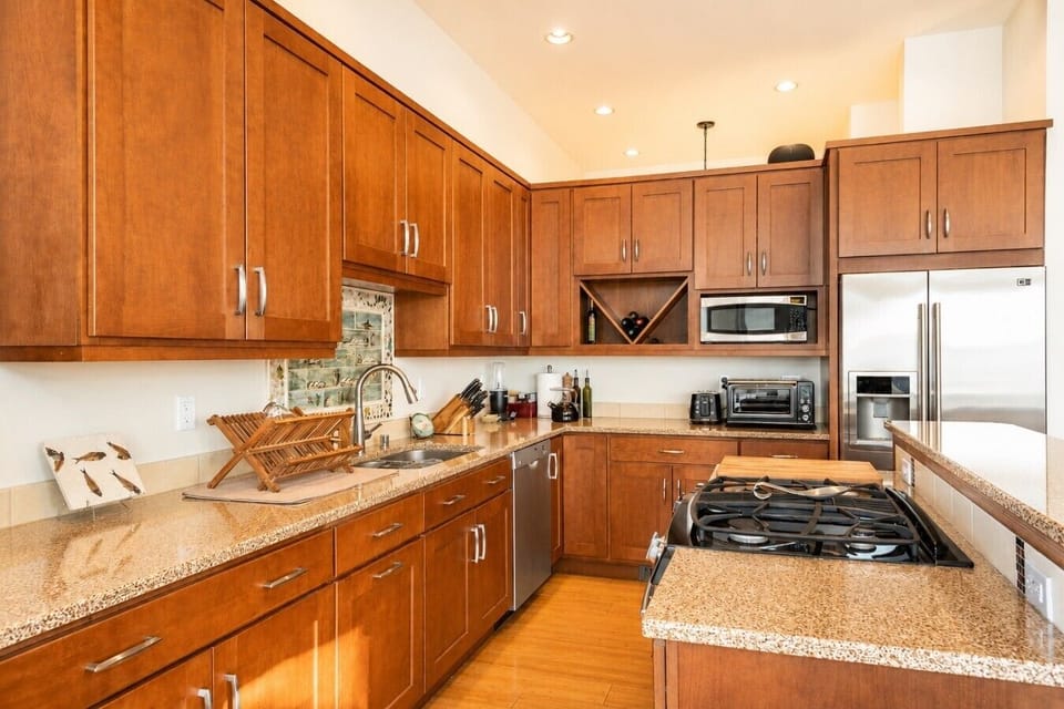 Spacious kitchen with premium wood cabinetry and views