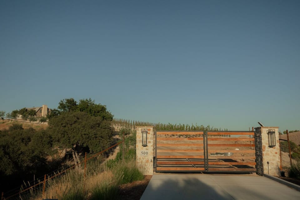 Arrive in style through the secure gated entry, framed by stone pillars and vineyard rows. This is your first warm welcome to a peaceful wine country retreat.
