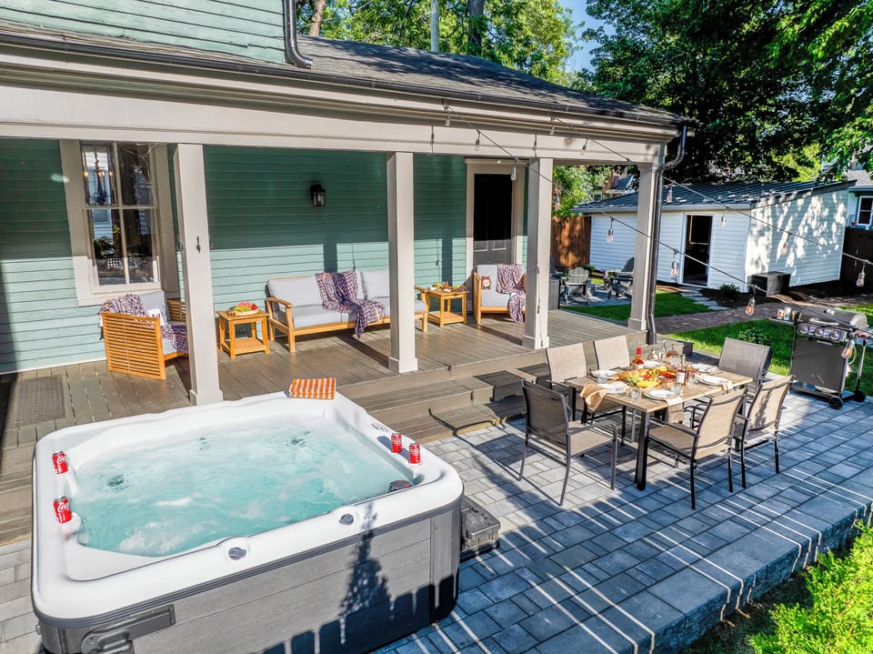 Hot tub, covered dining, a fire pit, string lights, and a game lawn come together to create the ultimate backyard retreat.