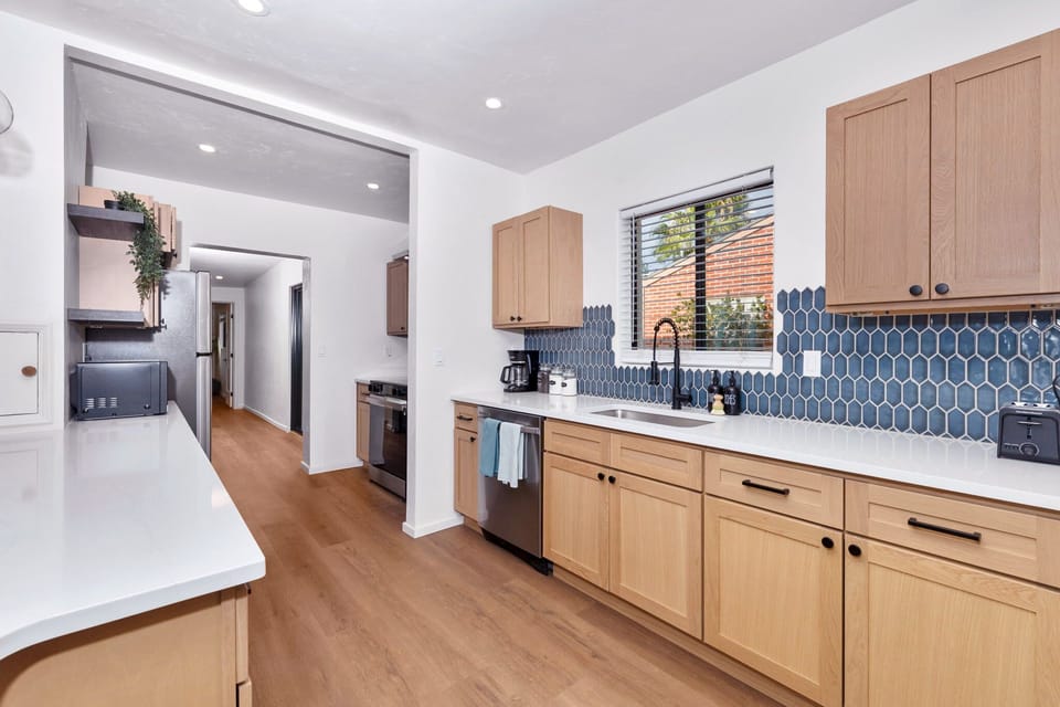 Complete kitchen featuring cookware, utensils, dinnerware, glassware, and small appliances like toaster and coffee maker.