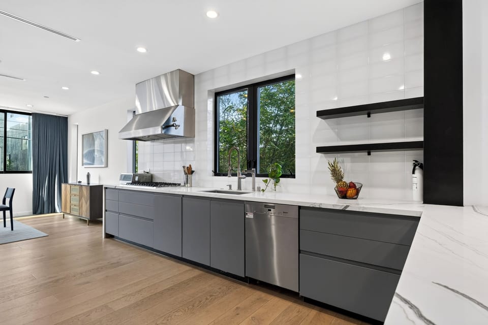 Chef's kitchen with a professional range hood and stainless appliances.