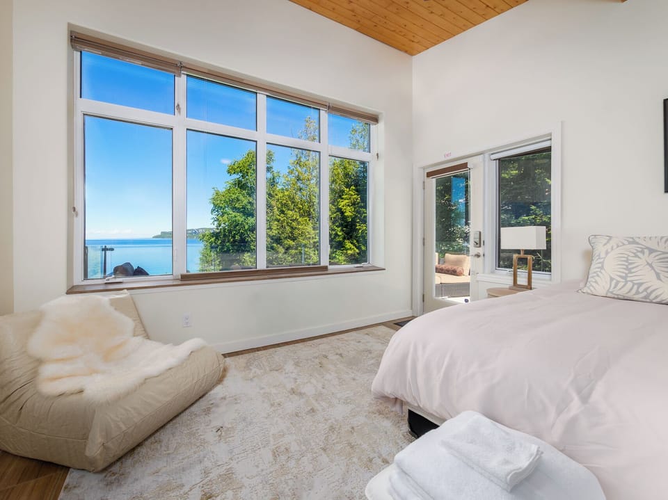 Large windows and direct access to the outdoor terrace let you enjoy the beauty of the waterfront from your bedroom.