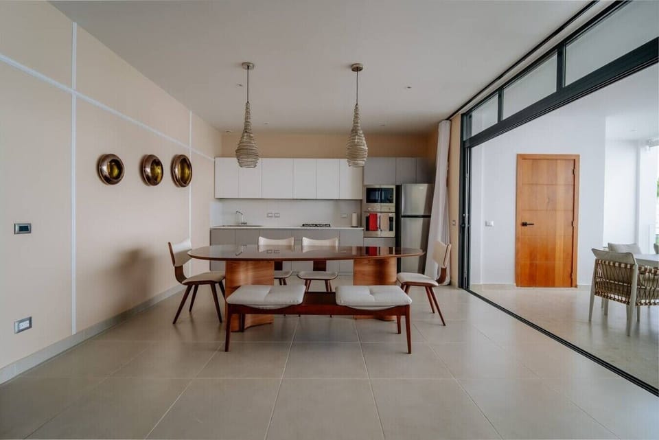 The open dining area flows seamlessly into the fully equipped kitchen.