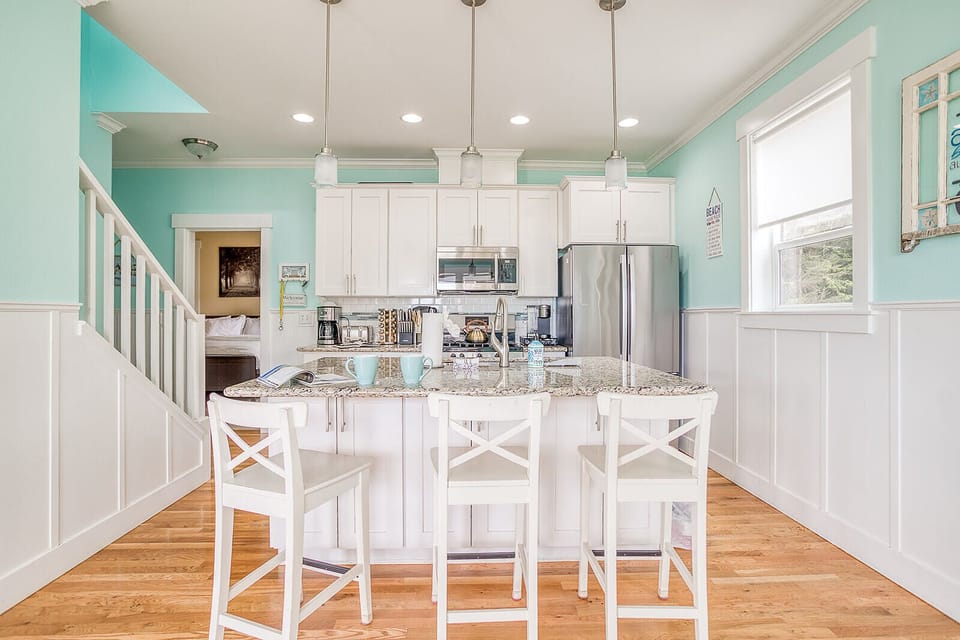 Your bright, breezy kitchen awaits with a spacious island, granite countertops, and stainless appliances—perfect for whipping up meals together and gathering for morning coffee.
