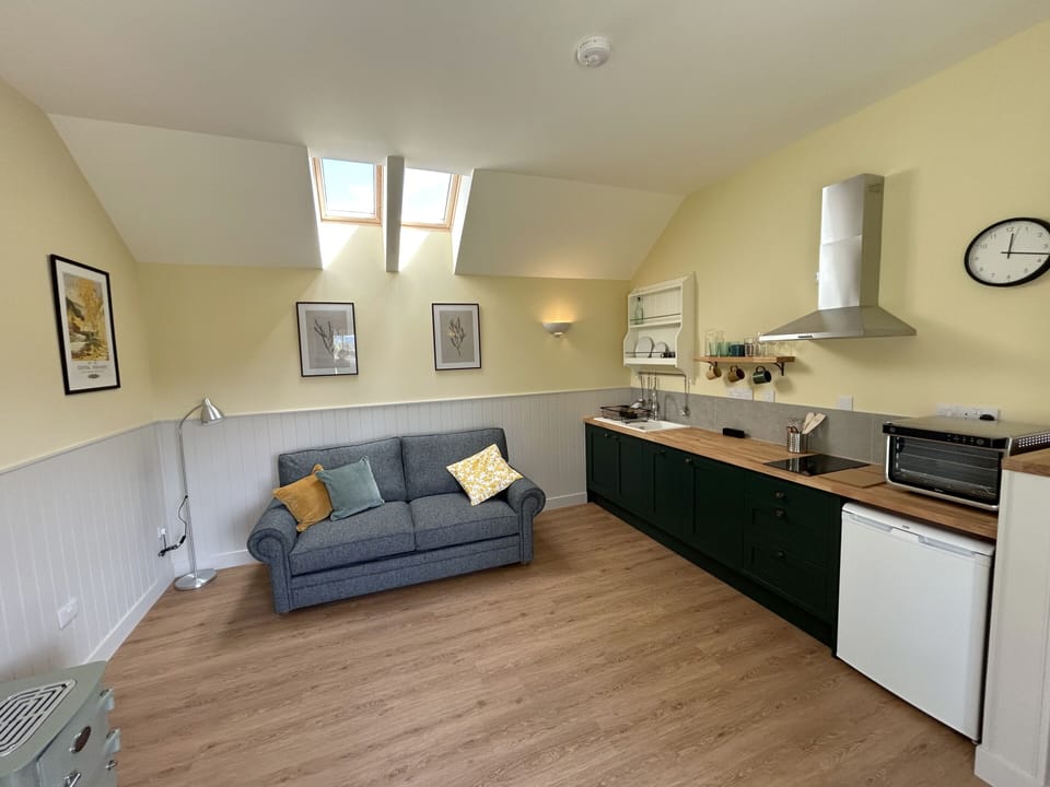No. 2's spacious living area and kitchen featuring an electric Everhot stove and a large double sofa bed.