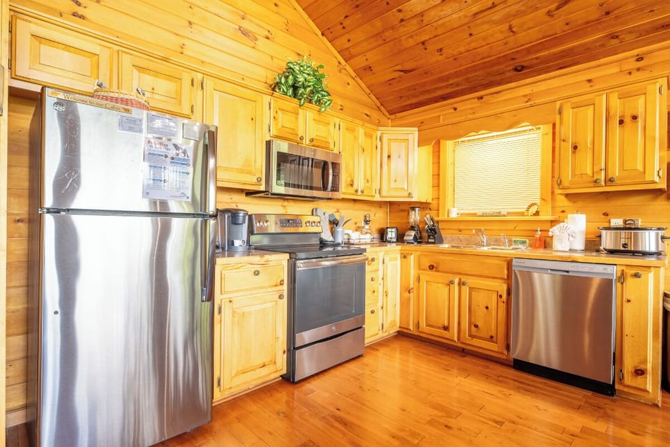 Step into your fully equipped kitchen with warm pine cabinetry, stainless steel appliances, and everything you need to cook, gather, and feel at home.