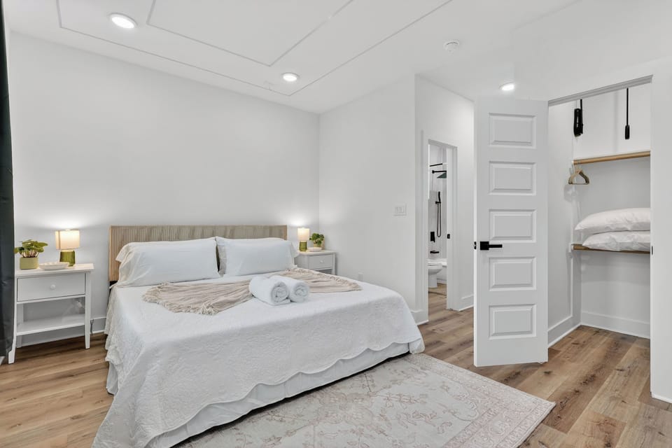 Bright, minimalist suite with plush queen bed, ensuite, and ample storage.