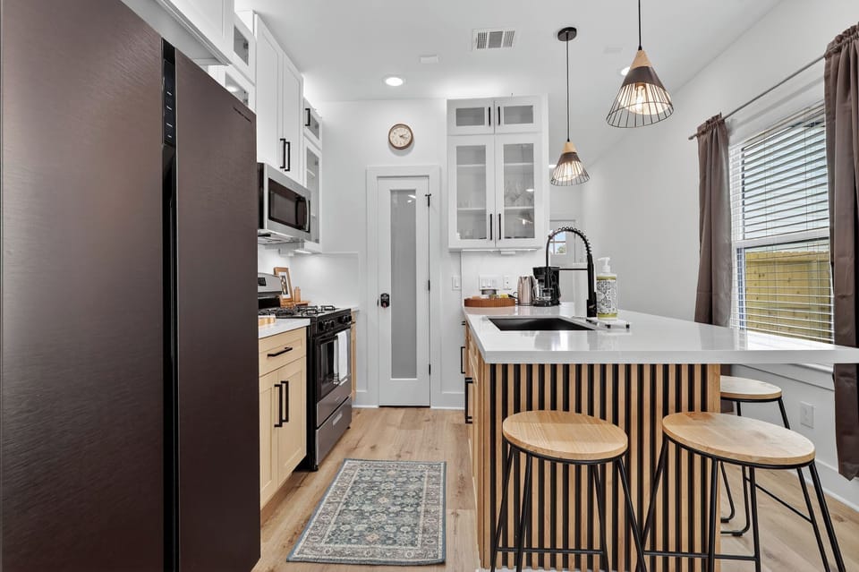 Stylish chef’s kitchen with island seating, gas range & coffee bar