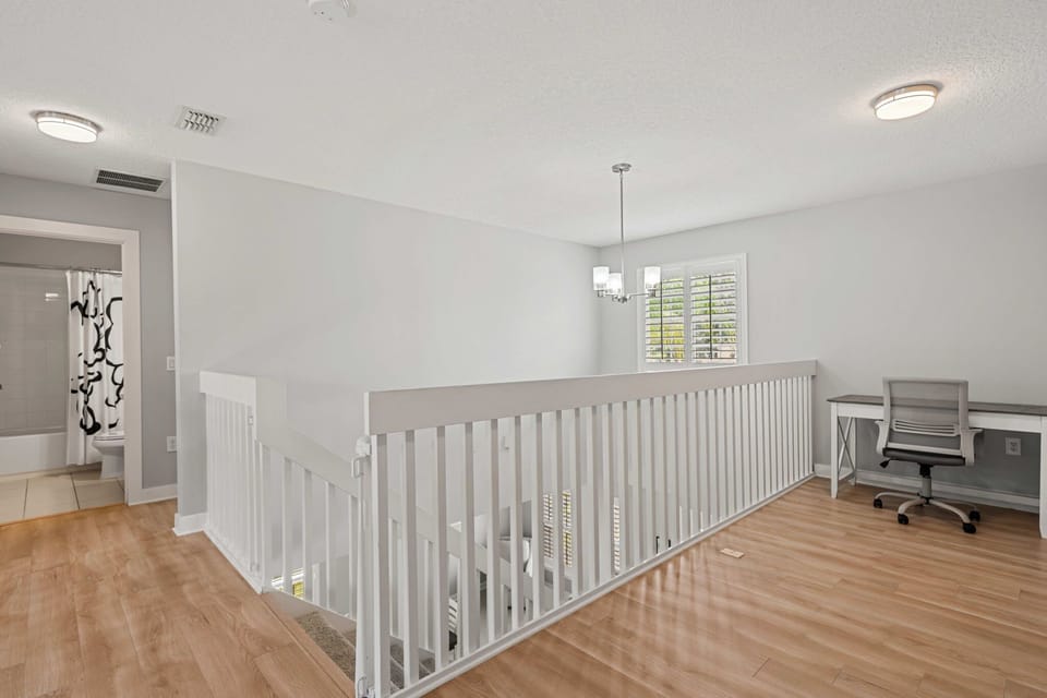 Open upstairs loft featuring a dedicated workspace overlooking the main living area—perfect for remote work, planning your next adventure, or catching up on emails.