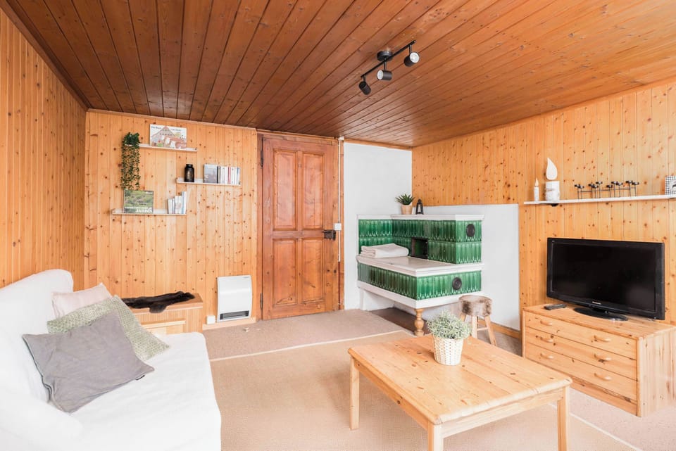 Comfortable living room with TV and seating for relaxing after a day in the mountains.
