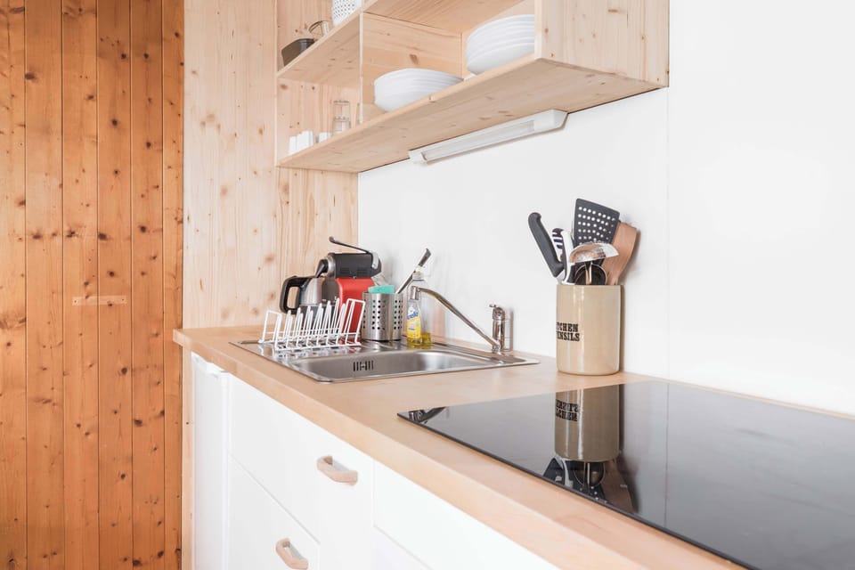 Well-equipped kitchen with cooking utensils and practical workspace.
