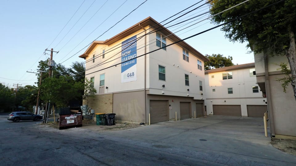 Modern multi-story exterior with attached garages and clean curb appeal