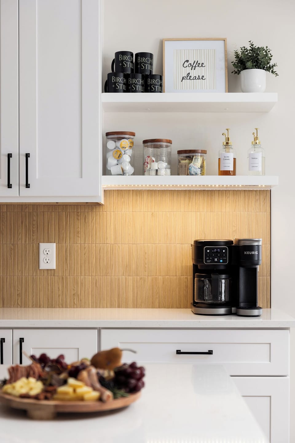 Bright kitchen with stocked coffee bar and sleek open shelving