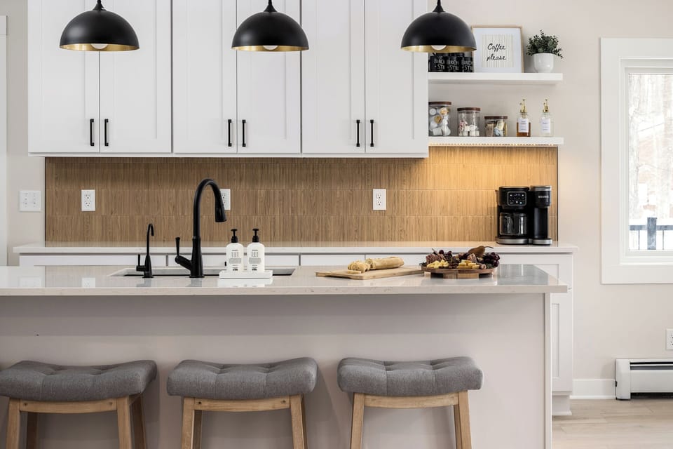 Modern kitchen with quartz island, coffee bar, and chic pendant lights
