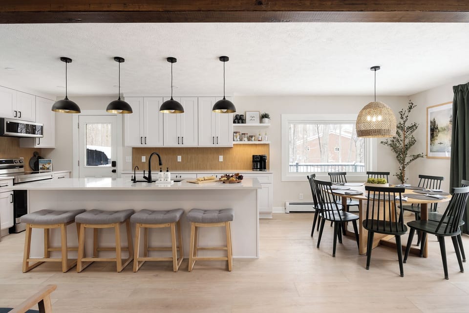 Airy chef’s kitchen with island seating and 8-seat dining nook