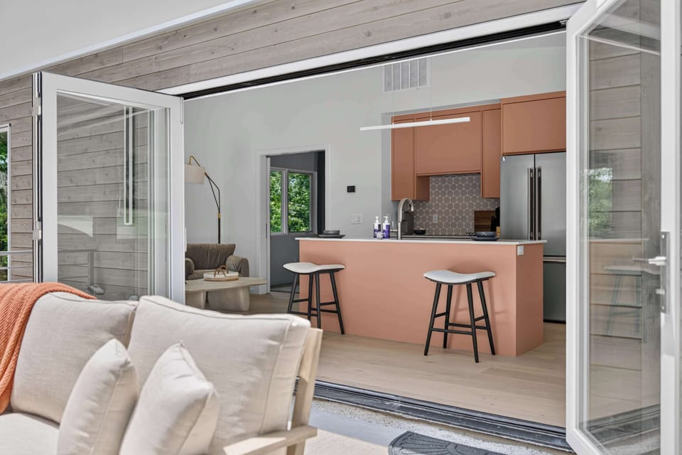 Head over to the guest house where light pours through the living space that flows into the open kitchen.
