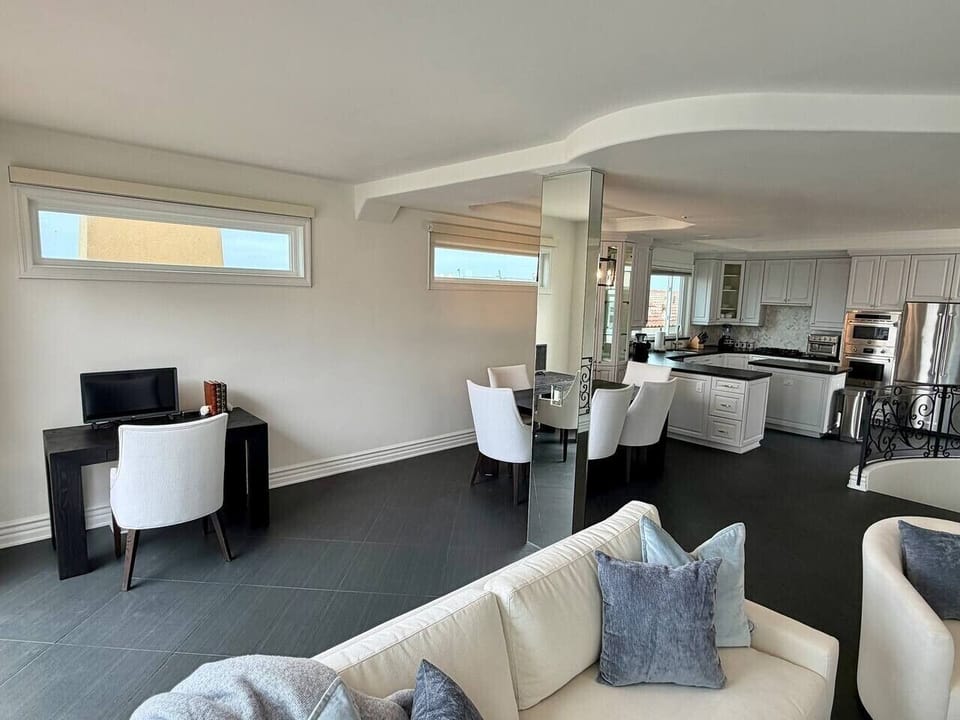 Here`s an Airbnb-friendly caption for each:  Living/dining open layout with desk: `Open living space with a dedicated workspace, easy to settle in whether you`re here to relax or get things done