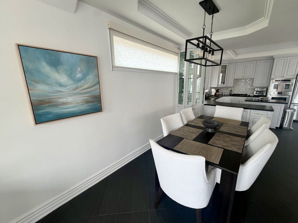 Open-concept living and dining area with French doors leading to a private balcony overlooking the marina