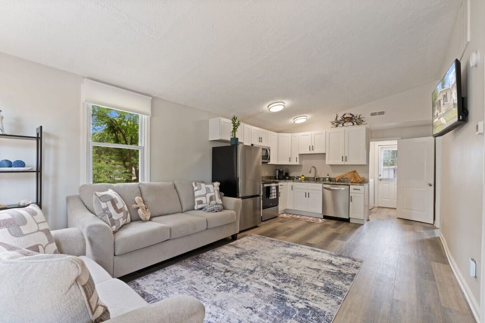 Bright, open-concept living room and fully equipped kitchen designed for relaxing and gathering together.