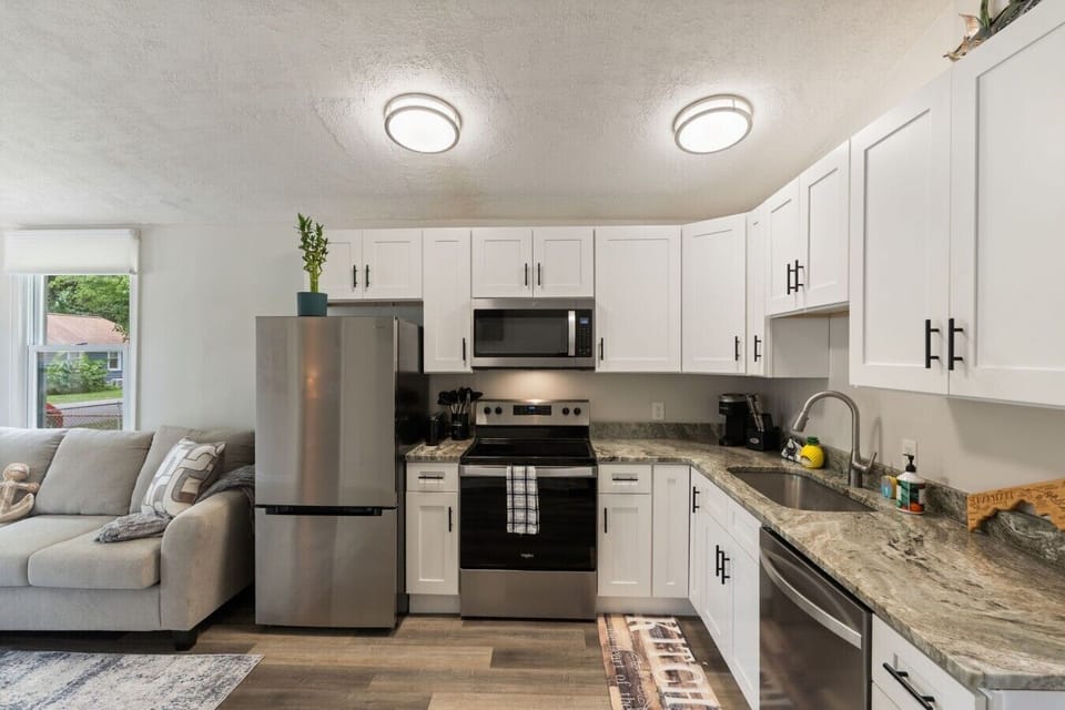 Modern kitchen equipped with full-size appliances, cookware, coffee maker, and everything needed for home-cooked meals.