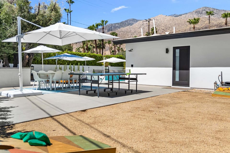 Backyard games with ping-pong, cornhole and outdoor dining